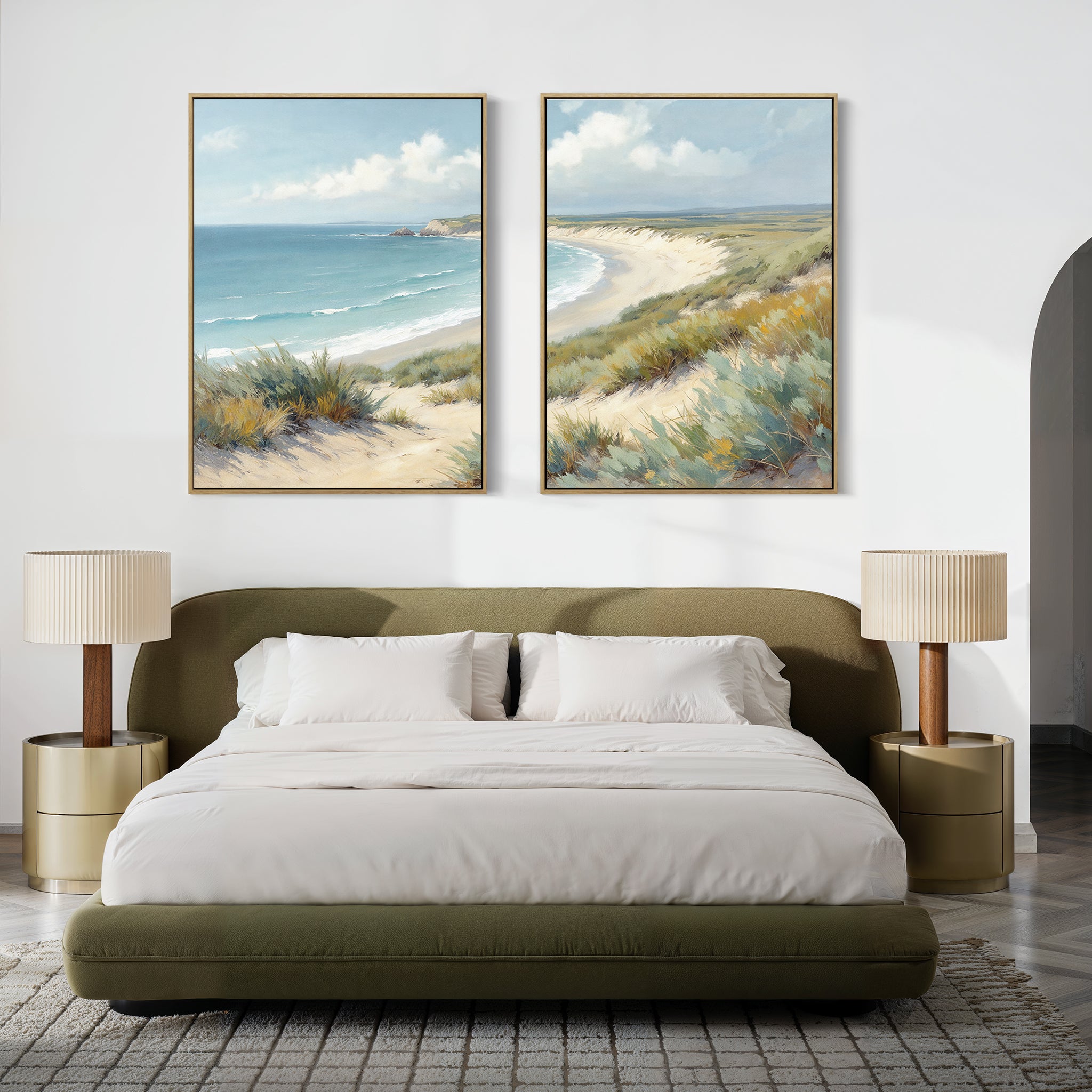 A modern bedroom with an olive-green bed, white bedding, matching nightstands with lamps, and two large "Sandy Shores - Set of 2" beach wall art pieces featuring serene landscape decor above the bed.