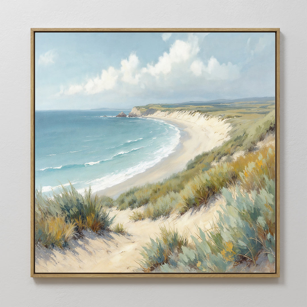 The Sandy Shores Canvas Art - Square features a framed coastal landscape with a sandy beach, gentle waves, grassy dunes, and a partly cloudy sky—ideal relaxing wall art for your home décor.