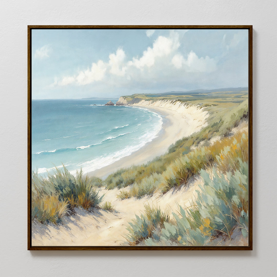 The Sandy Shores Canvas Art - Square features a coastal landscape with sandy beach, grassy dunes, gentle waves, and a partly cloudy sky—perfect wall art for beach lovers.