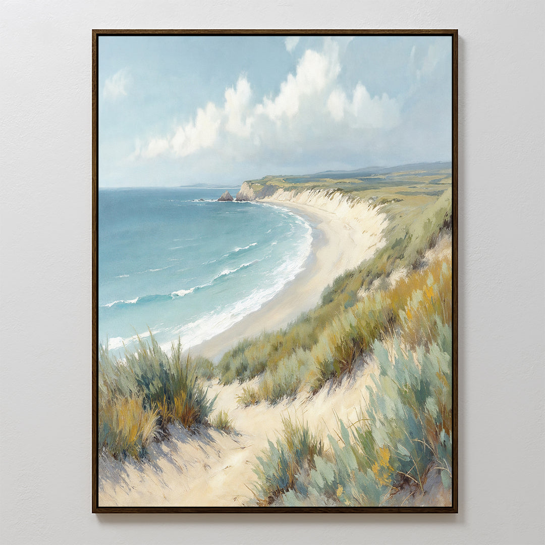 The Sandy Shores Canvas Art - Vertical features a framed coastal landscape of a sandy beach, grassy dunes, gentle waves, and a cloudy sky—ideal beach wall art to enhance any room.