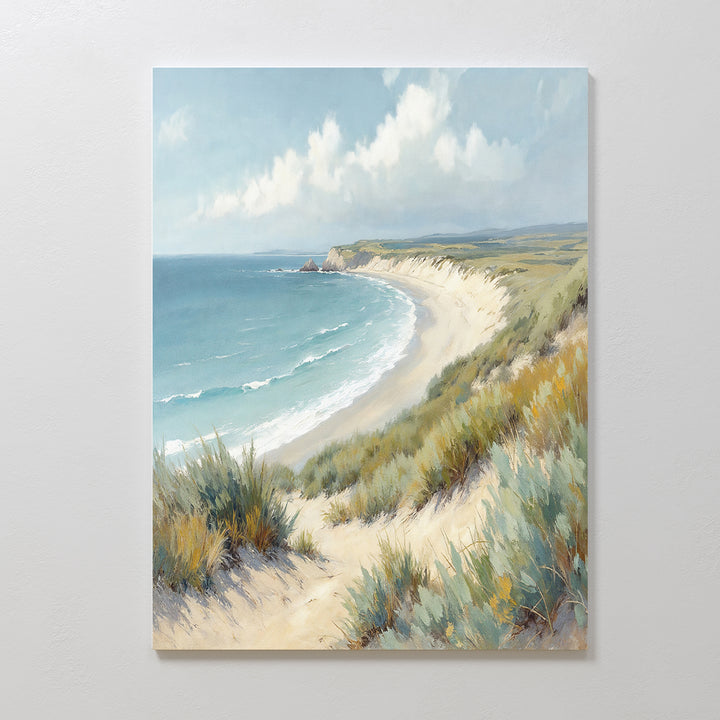 Sandy Shores Canvas Art - Vertical features a serene coastal scene of sandy beach, gentle waves, and grassy dunes beneath a cloudy sky—perfect wall art to bring tranquility to any space.