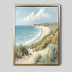 The Sandy Shores Canvas Art - Vertical adds a coastal touch to any room with gentle waves, grassy dunes, distant cliffs, and a blue sky—perfect framed beach wall art for your space.