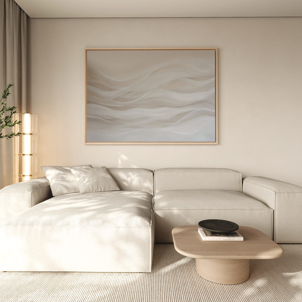 A modern living room with a light beige sectional sofa, neutral cushions, a light wooden coffee table with a black bowl, Sandy Hues Abstract Canvas Art on beige walls, and natural light streaming through sheer curtains.