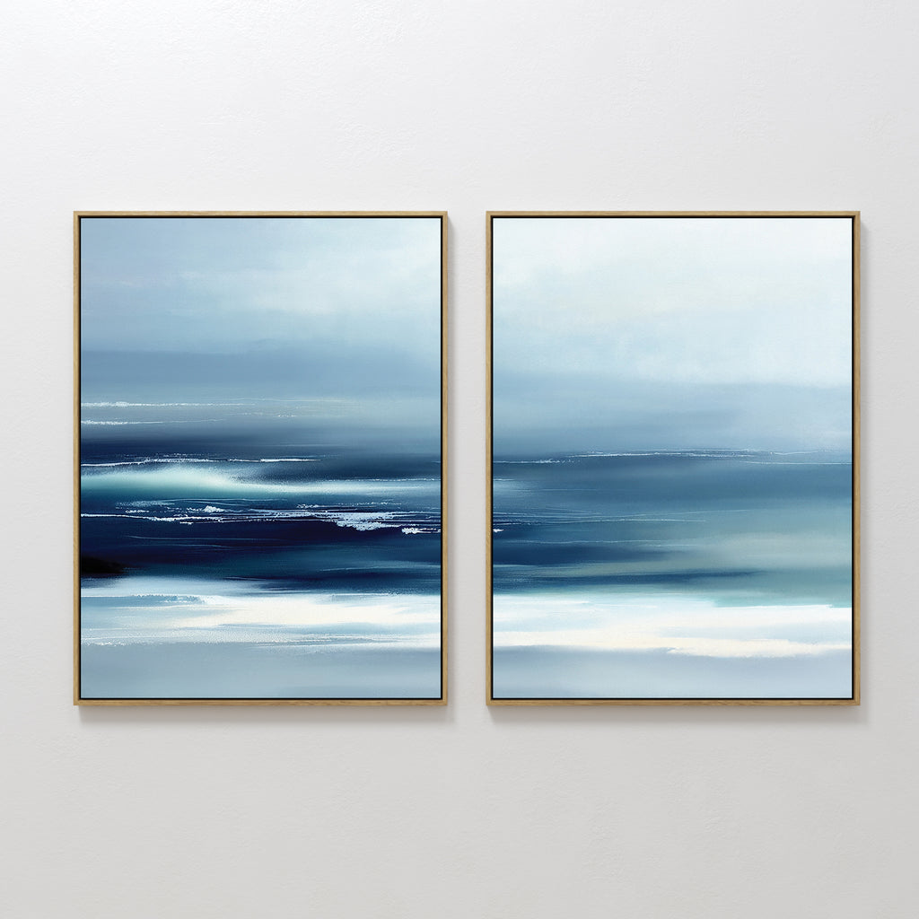 Sapphire Current - Set Of 2 features framed abstract prints with smooth blue and white gradients, evoking a tranquil seascape. Horizontal brushstrokes and soft blending create calming, modern wall art for any space.