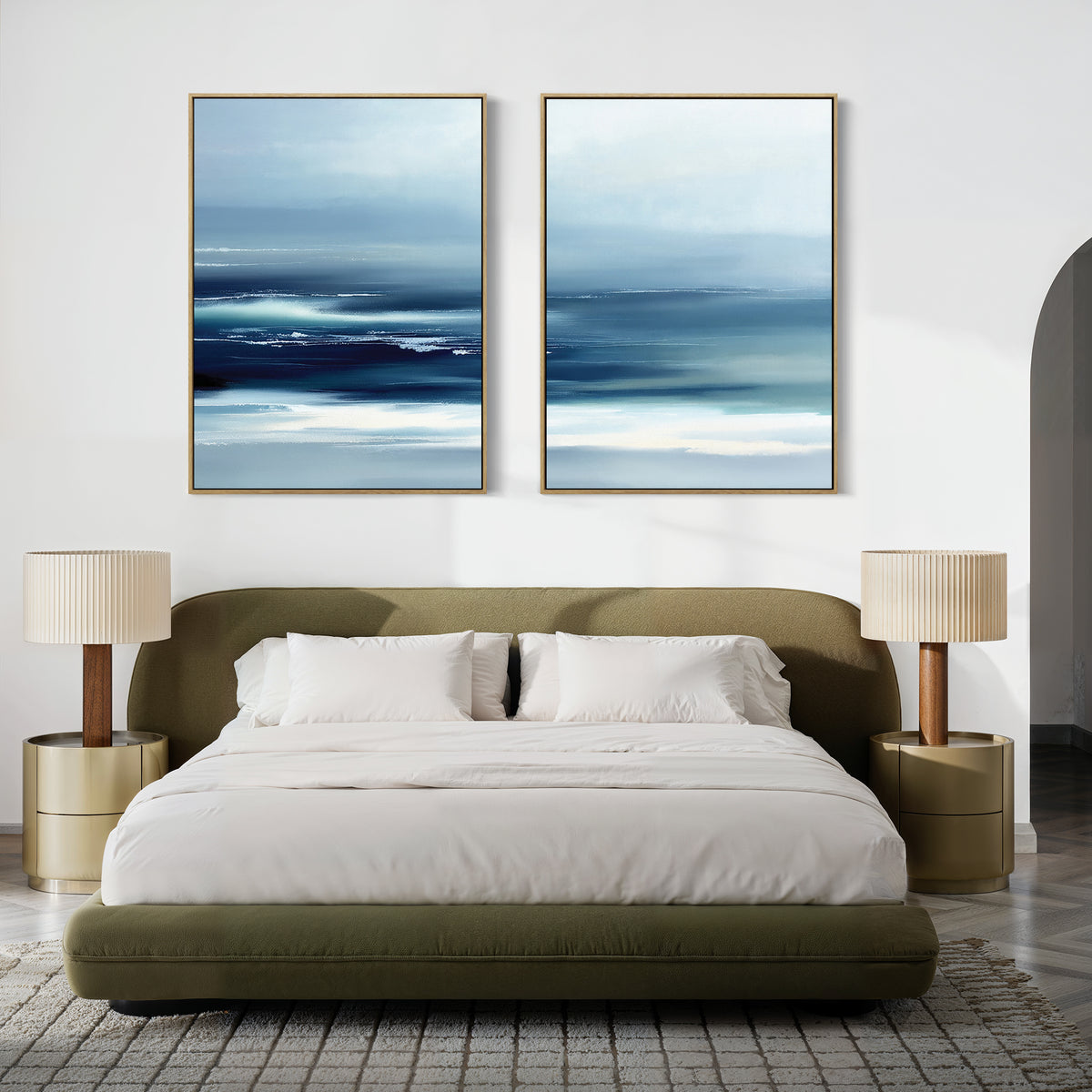 A modern bedroom with an olive green bed, white bedding, and beige nightstands is made serene by the Sapphire Current - Set Of 2 artwork, featuring large sapphire abstract prints hanging above the bed.
