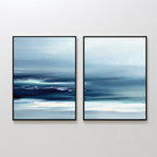 The Sapphire Current - Set of 2 features square blue and white abstract prints with soft, blended brushstrokes that evoke a tranquil seascape or misty Nordic horizon, displayed side by side on a white wall.