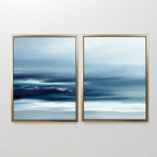 The Sapphire Current - Set Of 2 features abstract art in gold frames with soft, horizontal streaks of blue, white, and navy. These tranquil pieces evoke a serene seascape, blending minimal design and calming colors—ideal for Nordic Park-inspired decor.