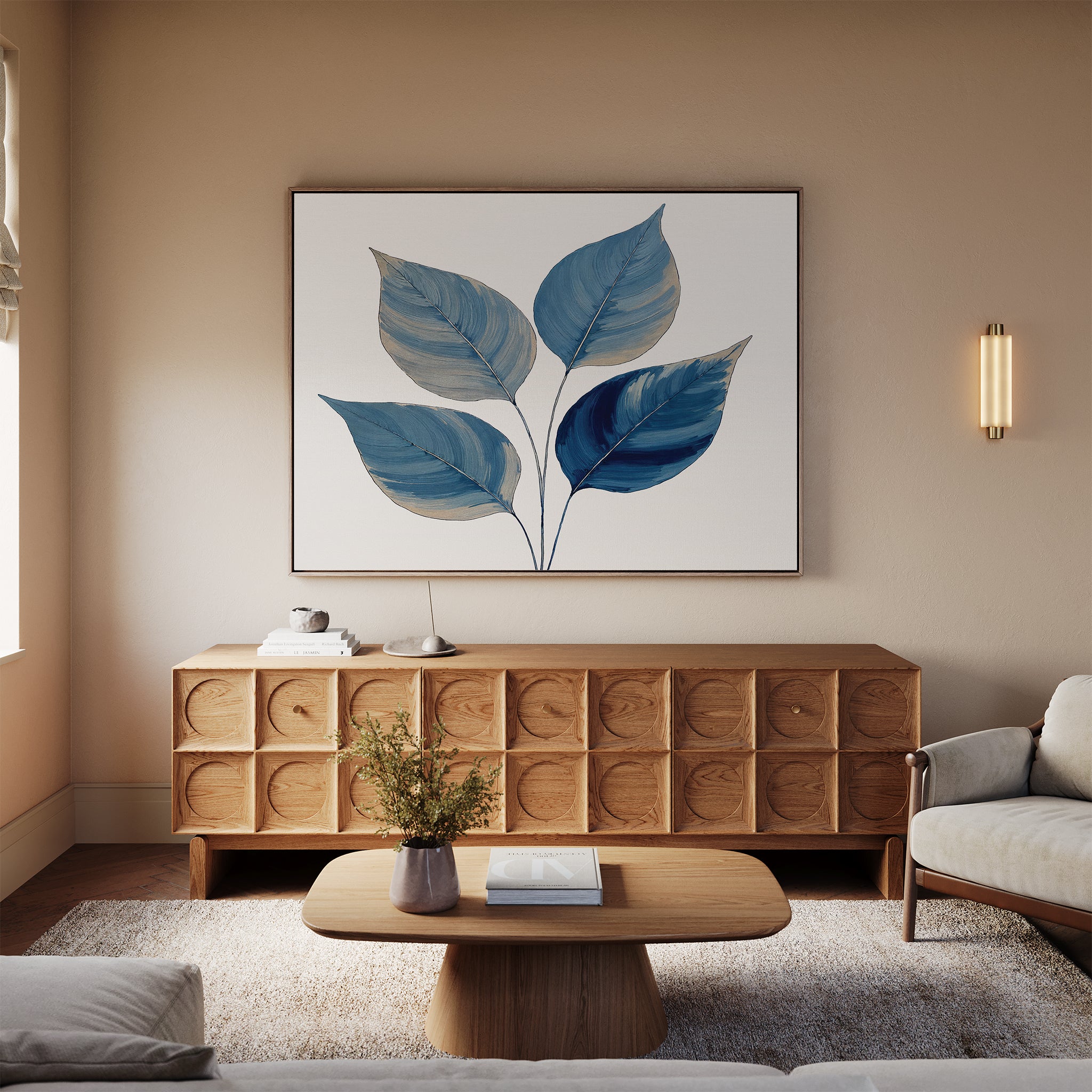 A modern living room features a light wood sideboard, beige sofa, wooden coffee table with a vase, and the Sapphire Leaves Canvas Art - Horizontal adding vibrant color above the sofa, all bathed in soft natural light from the window.