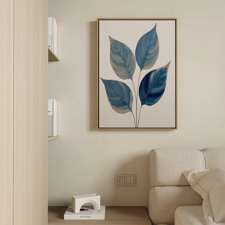 A minimalist living room with a beige sofa, light wood shelf of books, and the Sapphire Leaves Canvas Art - Vertical hanging on a cream wall, creating a calming, Nordic Park-inspired atmosphere.