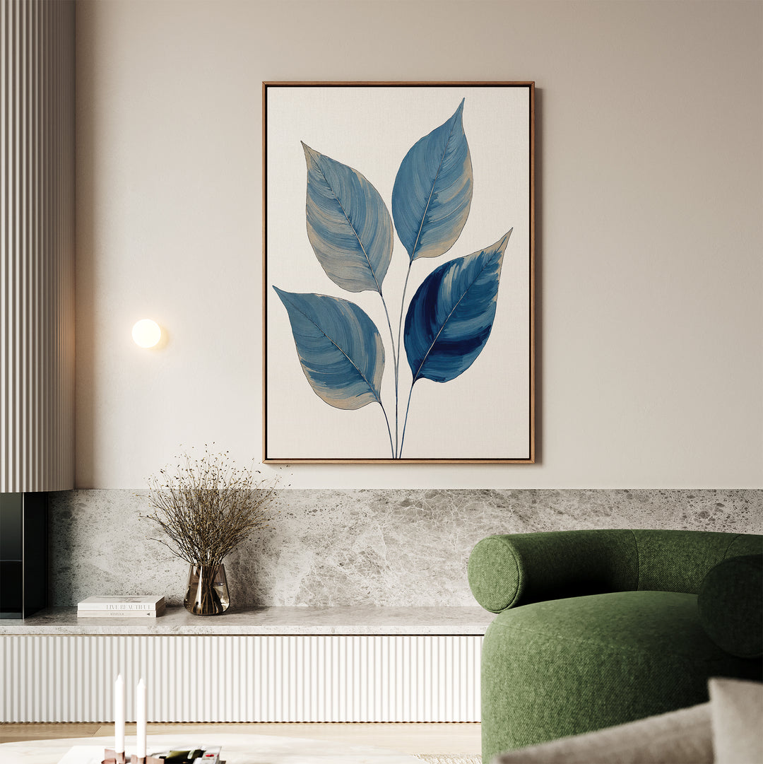 A modern living room features calming Sapphire Leaves Canvas Art - Vertical, a green curved sofa, a marble bench with dried flowers in a vase, soft neutral walls, and a round wall light.