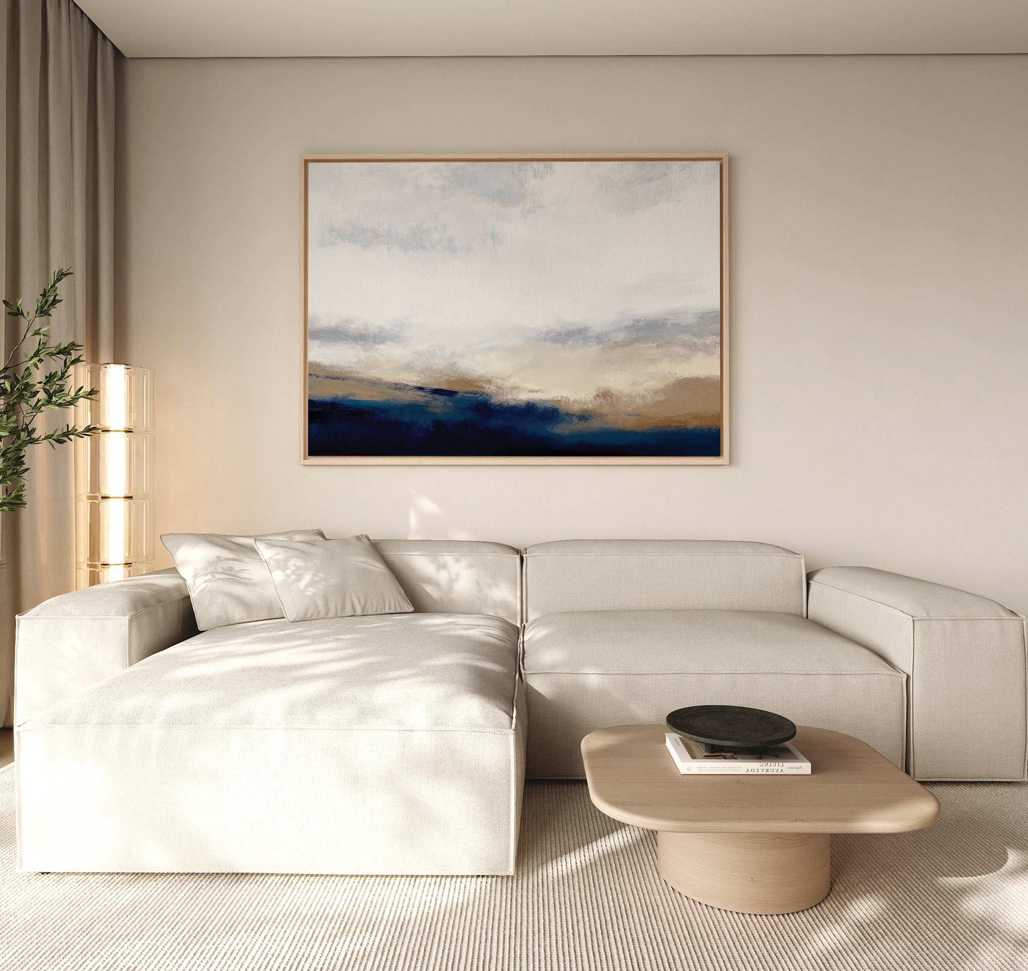 A modern living room with a light beige sectional, low wooden coffee table, black bowl, and tall plant is filled with natural light. The Sapphire Tides Canvas Art - Horizontal adds a contemporary touch as striking wall decor.