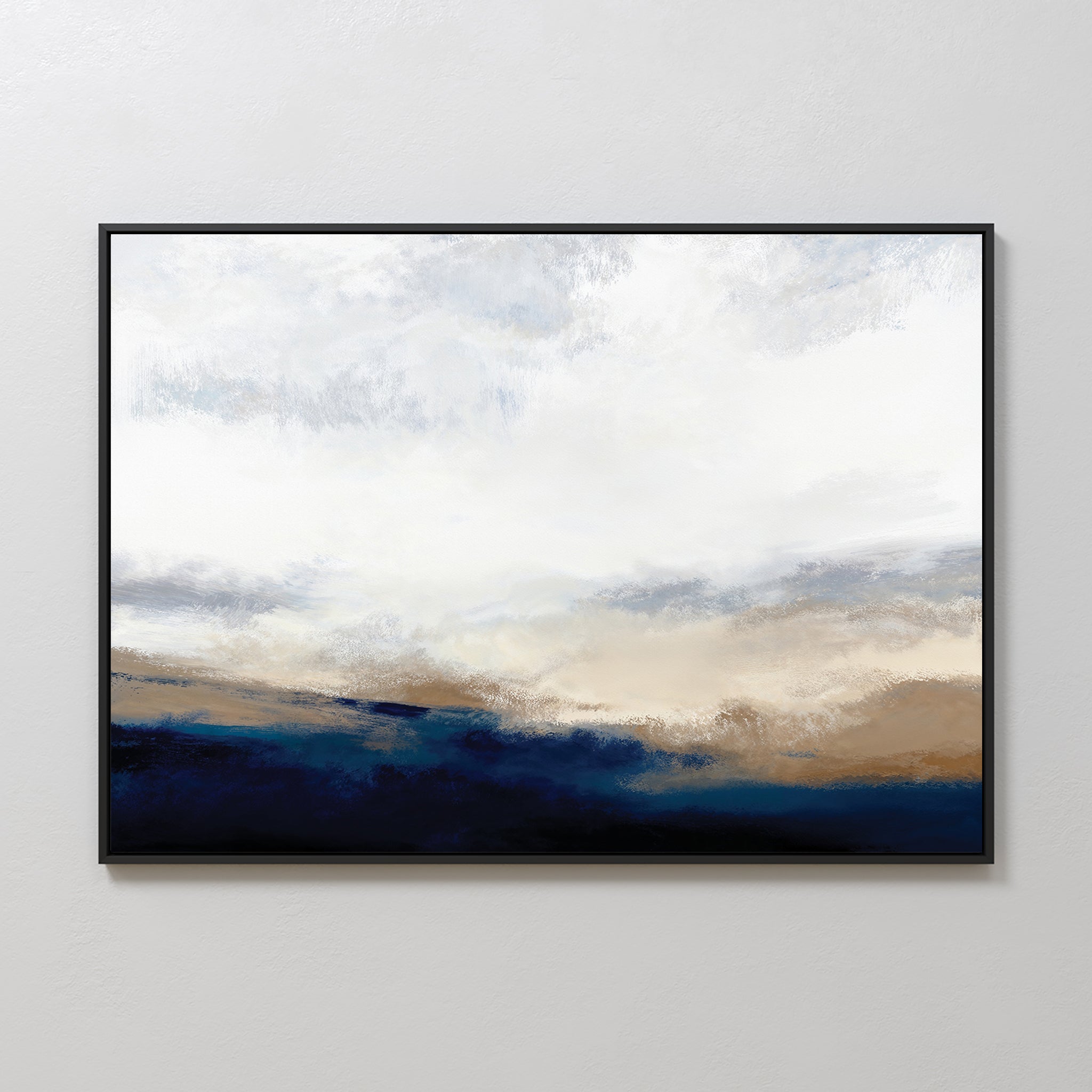 Sapphire Tides Canvas Art - Horizontal features soft brushstrokes and a white-gray sky above deep blue and tan hues, creating serene cobalt tones. This modern wall decor comes framed in black, ideal for hanging on a light-colored wall.