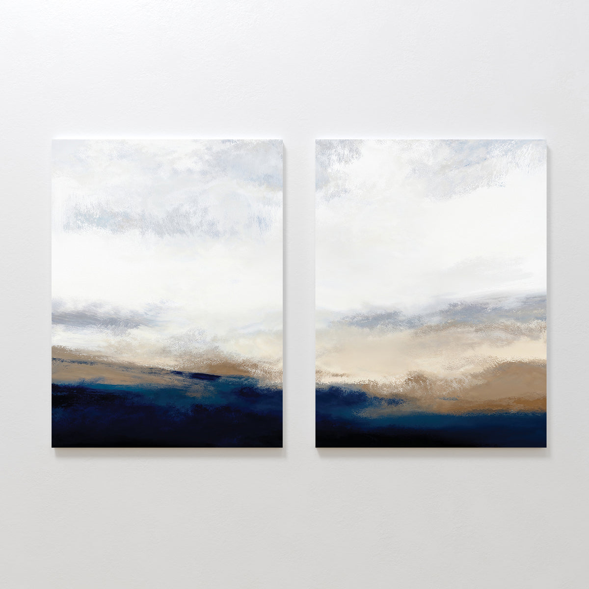 Sapphire Tides - Set Of 2 features abstract landscape paintings with soft brushstrokes in cobalt blue, beige, and white, blending to evoke a peaceful sky and horizon—ideal wall decor for modern living rooms.