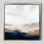 Sapphire Tides Canvas Art - Square: Abstract print in a gold frame, with soft cobalt blues blending into beige and white above—evoking a cloudy sky over a landscape, ideal for adding modern elegance to your living room.