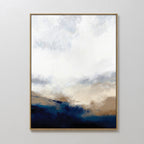 The Sapphire Tides Canvas Art - Vertical features a gold frame and soft blends of white, beige, and cobalt blue, evoking a cloudy sky above a dark landscape—ideal for modern living rooms with a minimal aesthetic.