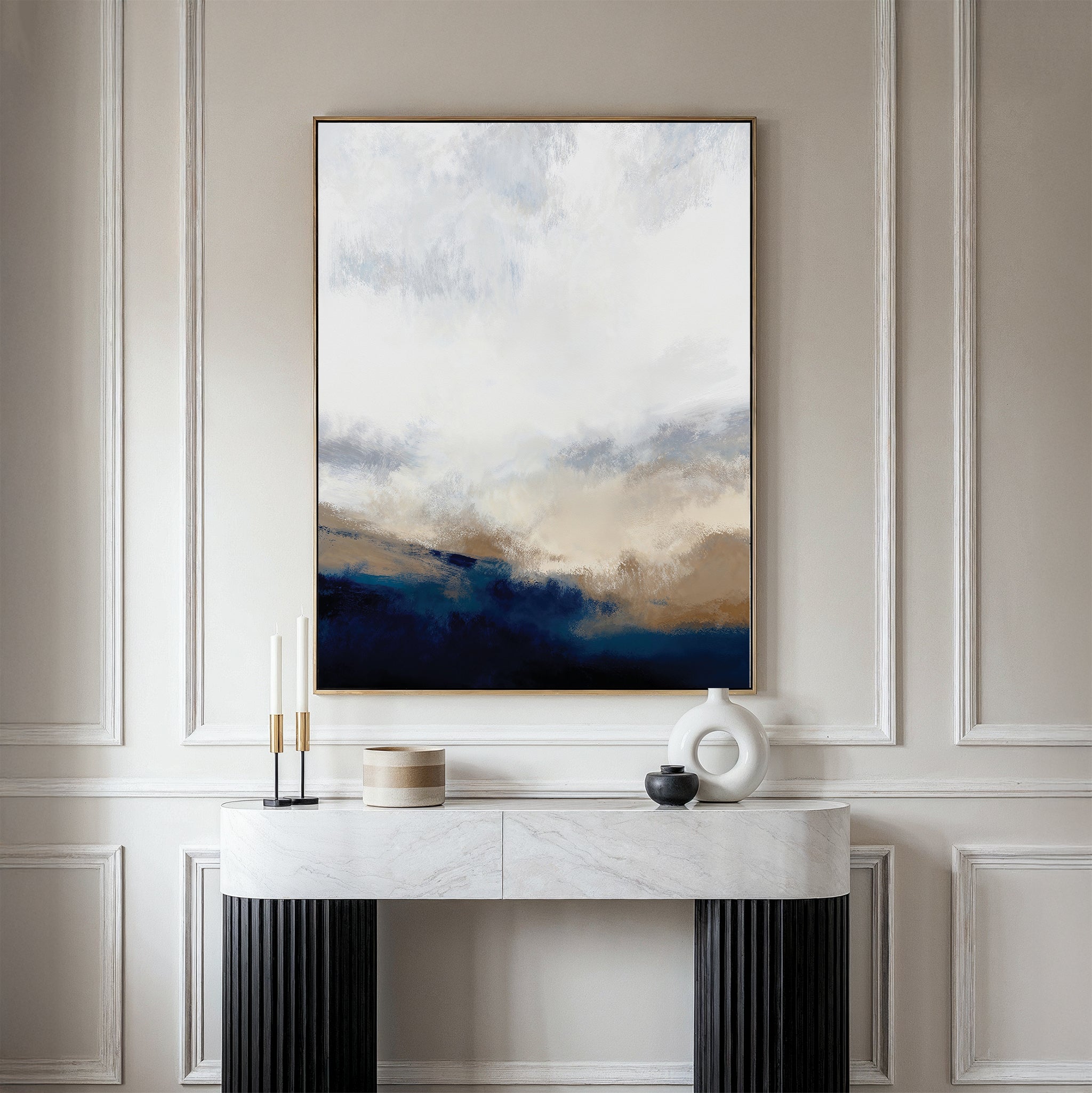 A modern entryway features a white marble console table, decorative accents, and the Sapphire Tides Canvas Art - Vertical in neutral and cobalt blues on a beige paneled wall—perfect living room inspiration.