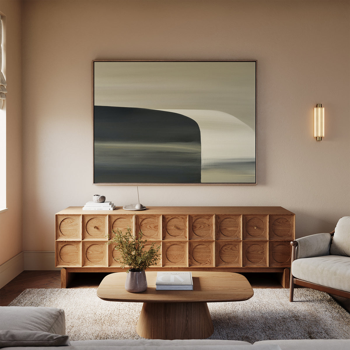 A modern living room with light walls, a wooden sideboard, the Sculptural Forms Canvas Art - Horizontal, a beige sofa, wooden coffee table, small vase with flowers on a light rug creates an inviting space for minimalist decor.