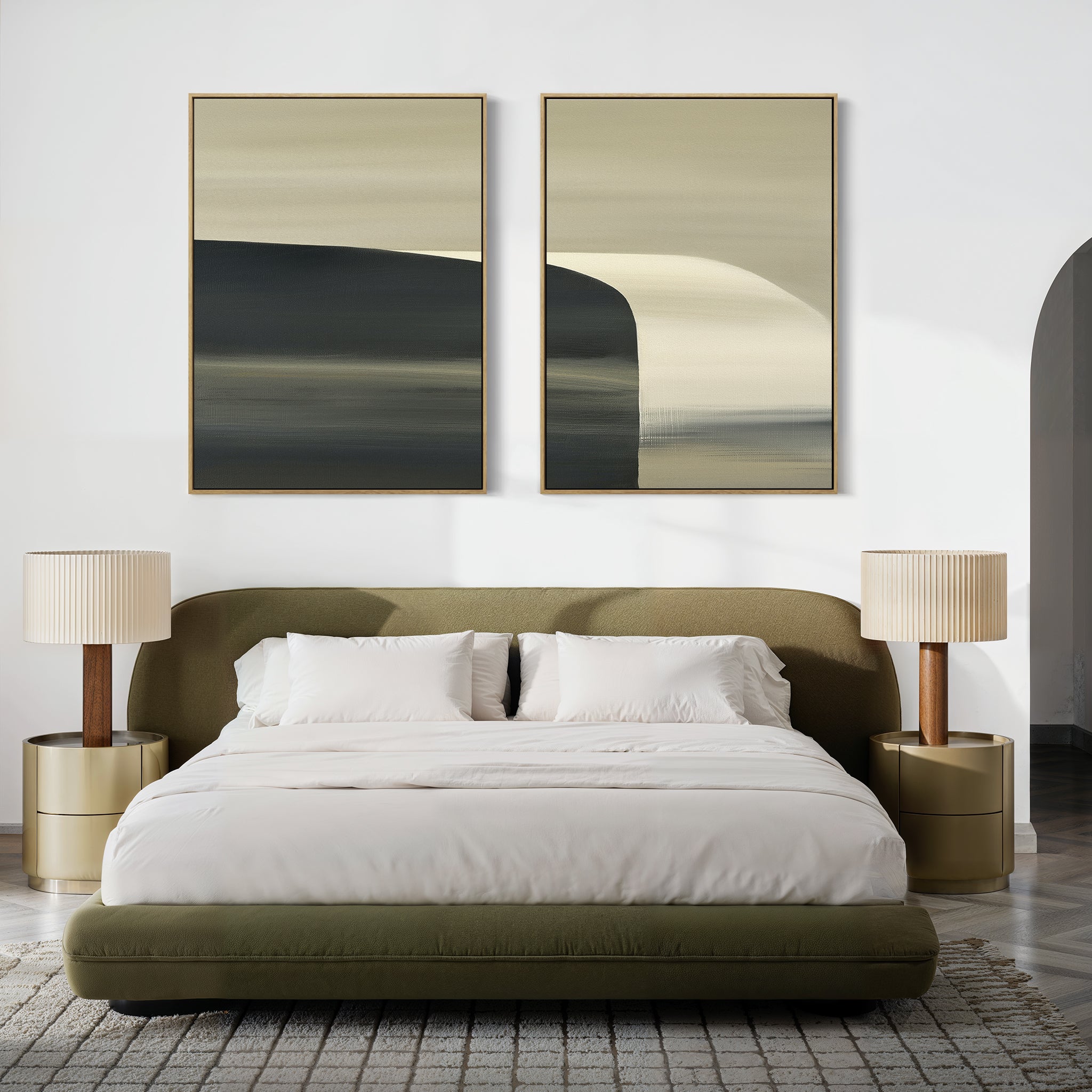 A modern bedroom featuring a green upholstered bed, white bedding, gold nightstands with lamps, and "Sculptural Forms - Set Of 2" abstract paintings above the bed creates a cozy, stylish atmosphere in neutral tones.