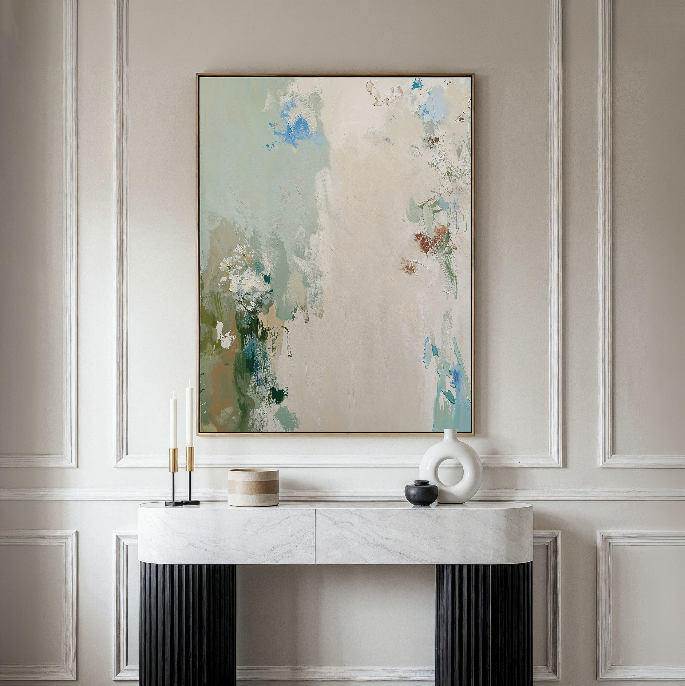 The Serenity Garden Abstract Canvas Art, with soft pastel tones, hangs above a marble console table adorned with candlesticks, a round box, black bowl, and white sculptural vase for an elegant, modern look.
