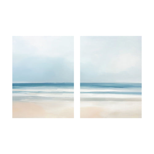 Blurred Beach Scene, featuring two panels of tranquil wall art with a soft, painterly beach scene of blue water and a pale sandy shore.