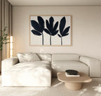 A modern living room with a beige sectional, light wood coffee table, and black decorative bowl features the Shadow Stems Canvas Art - Horizontal above the sofa. Neutral tones and natural light fill the space.