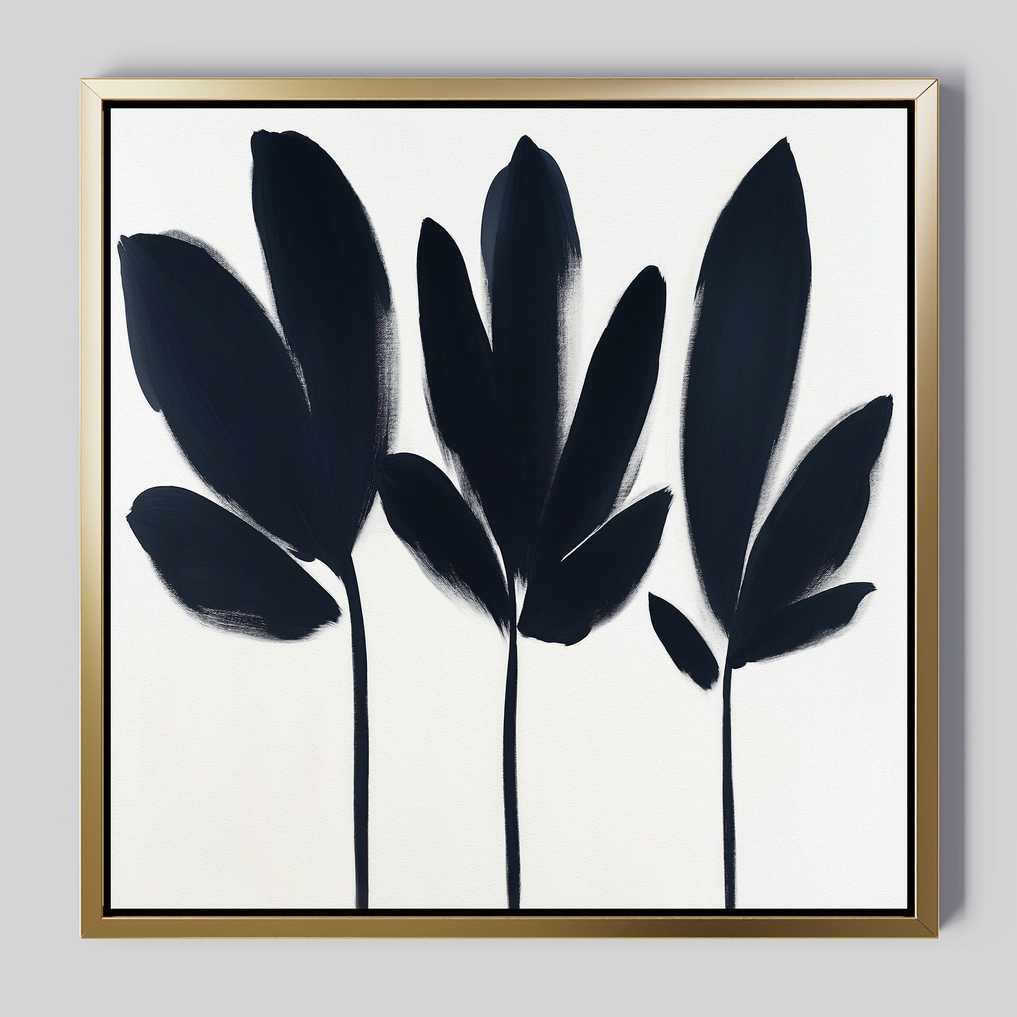 The Shadow Stems Canvas Art - Square features three black botanical silhouettes on a white background with bold, simple brushstrokes and a thin gold frame—creating a modern, elegant accent for contemporary living rooms.