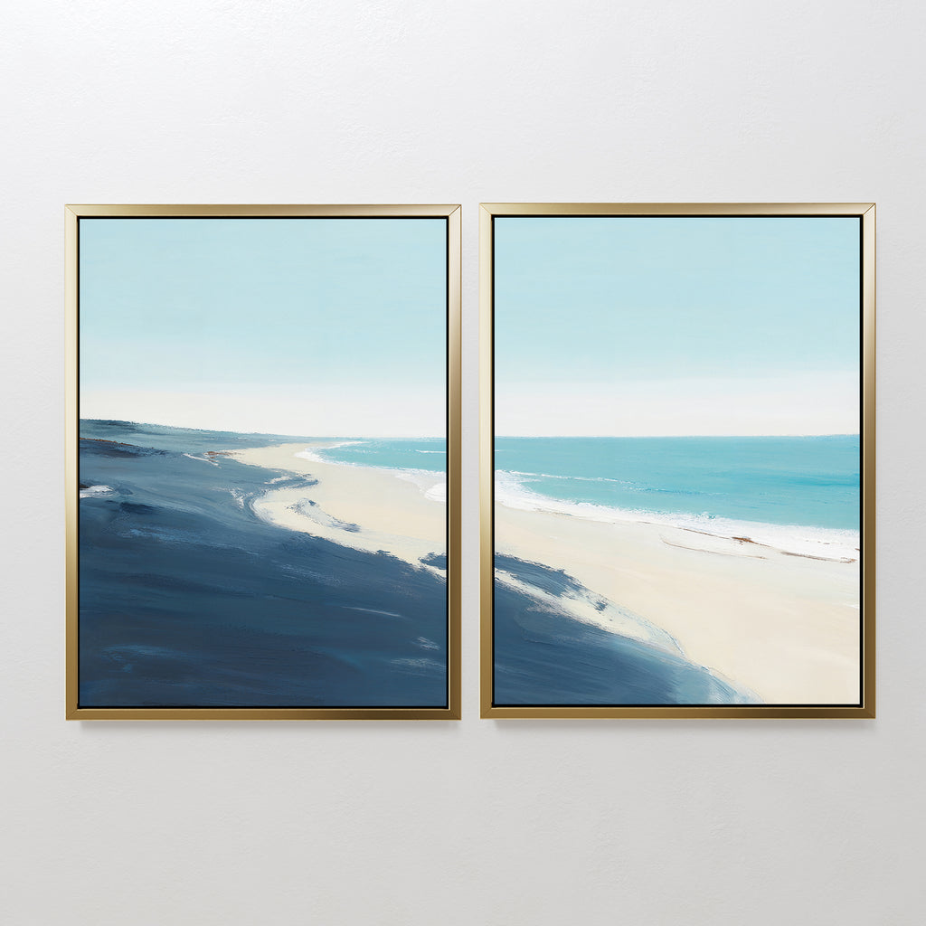 Shifting Tides - Set of 2 features two framed coastal canvas prints showcasing a serene beach with blue waves, sandy shore, and pale sky in a soft minimalist style—ideal as calming seaside wall art.