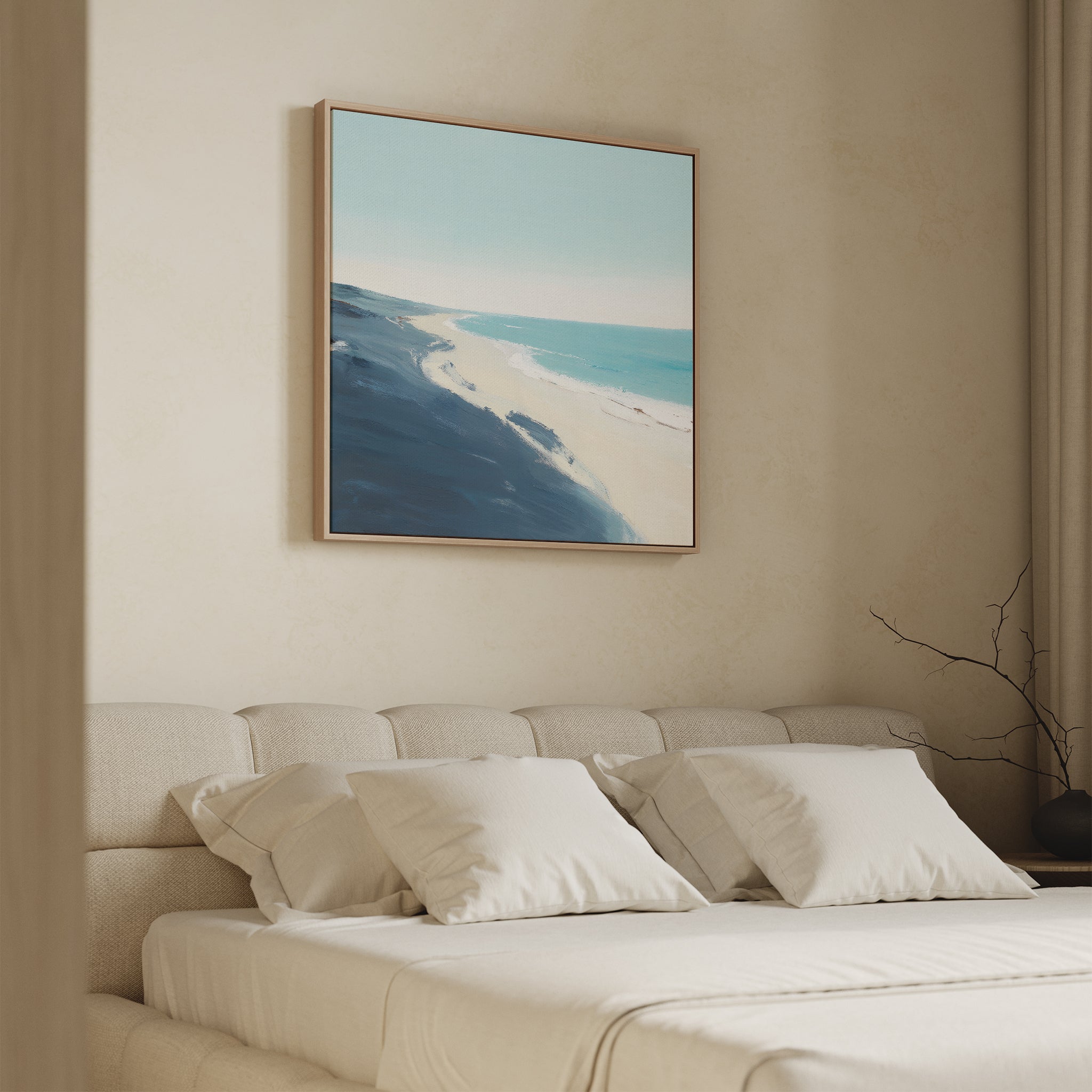 A minimal bedroom features a beige bed, white pillows, and the Shifting Tides Canvas Art - Square framed above. Soft lighting and simple decor enhance the calm, neutral ambiance.