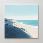 The Shifting Tides Canvas Art - Square features a minimalist beach scene with soft waves, pale sand, deep blue dunes, and a light blue sky. Smooth brushstrokes and gentle color transitions create a serene seaside effect.