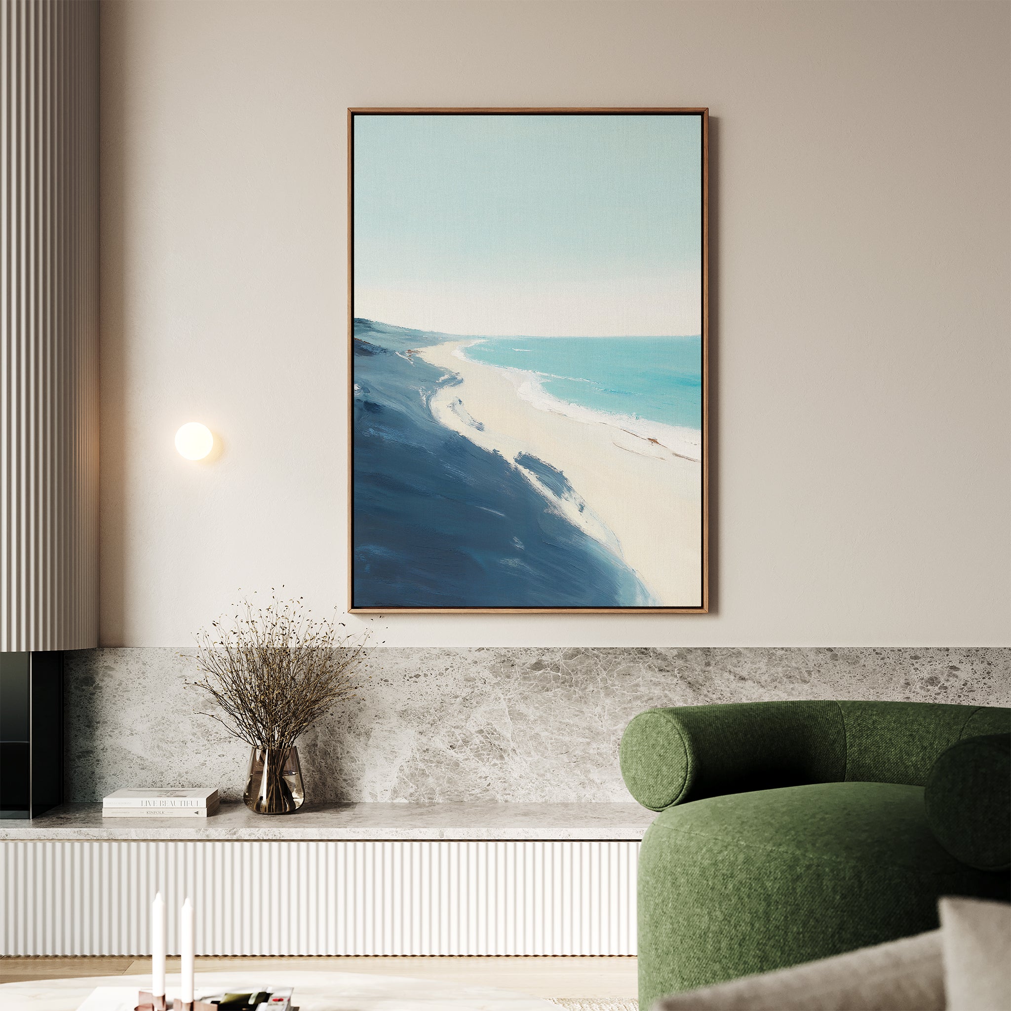 A modern living room with a green curved sofa, Shifting Tides Canvas Art - Vertical above, a round wall light, and a vase of dried flowers on a marble ledge. The space features neutral tones and minimalist Nordic Park-inspired decor.