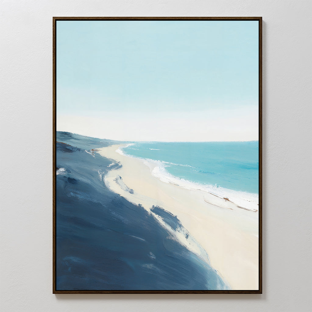 The Shifting Tides Canvas Art - Vertical features a tranquil beach scene with soft blue skies, turquoise waves, sandy shore, and dark blue cliffs in the foreground, all viewed from an elevated perspective.