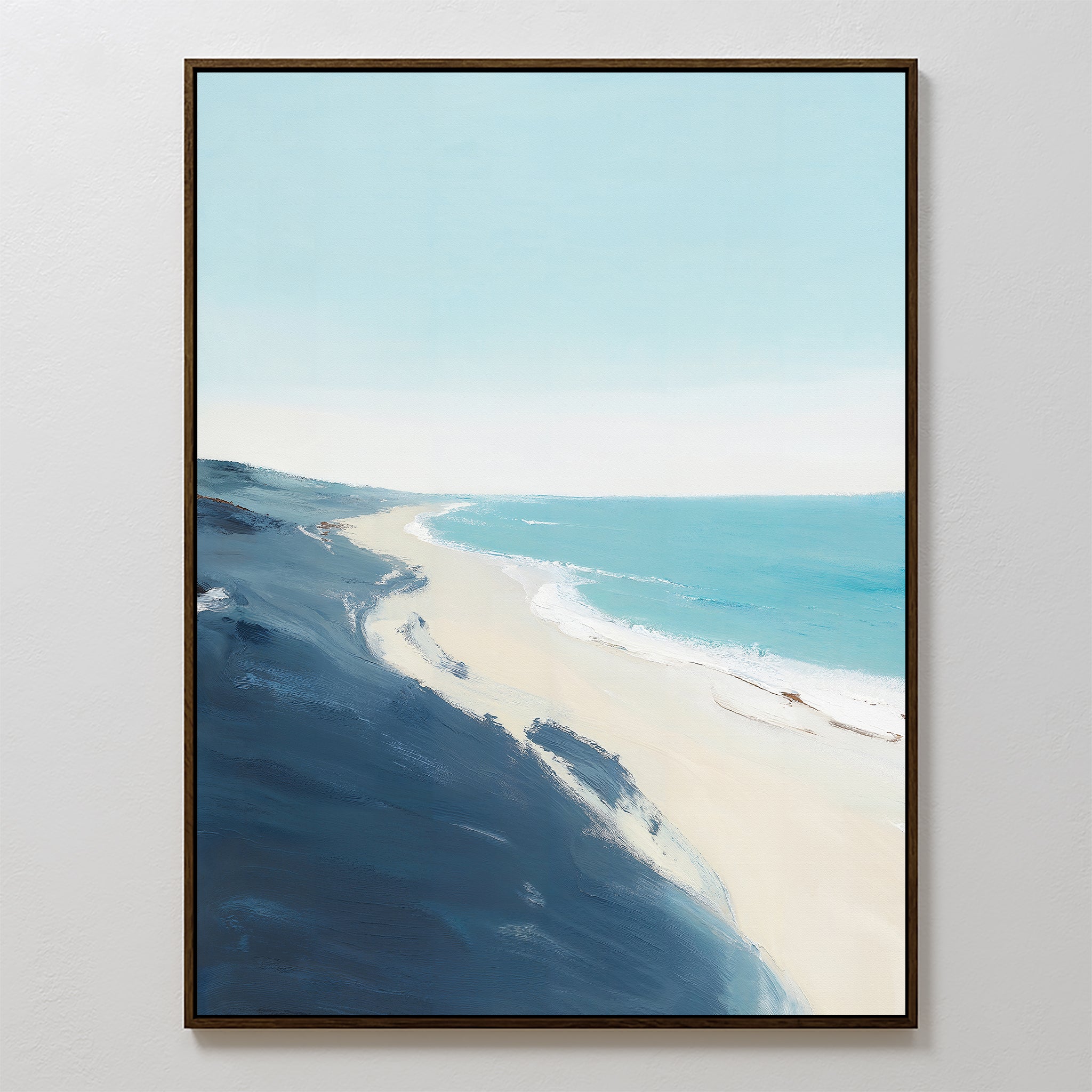 The Shifting Tides Canvas Art - Vertical features a tranquil beach scene with soft blue skies, turquoise waves, sandy shore, and dark blue cliffs in the foreground, all viewed from an elevated perspective.