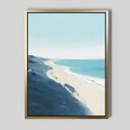 Shifting Tides Canvas Art - Vertical features a serene beach scene with blue waves, sandy shore, and soft sky in abstract brushstrokes. The gold frame adds elegance to the light gray background—ideal coastal wall art.