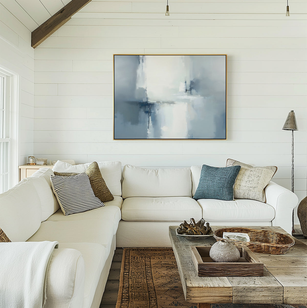 Bright living room with white shiplap walls, a large white sectional sofa with assorted pillows, a rustic wooden coffee table, and the Silver Cross Formation Canvas Art - Horizontal displayed above the sofa.