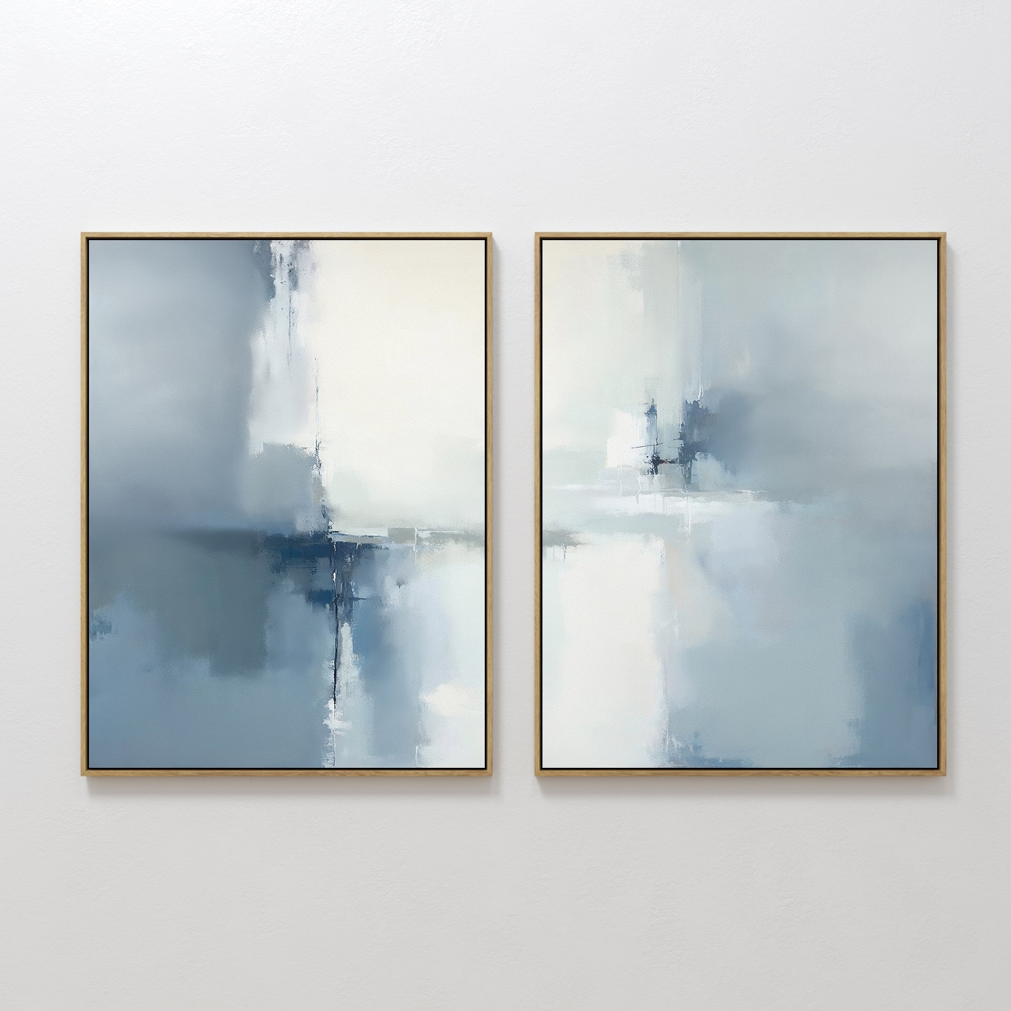 The Silver Cross Formation - Set Of 2 features atmospheric abstract prints in soft blue, white, and gray, each gold-framed and ideal for modern living rooms seeking a calm, minimalist look.