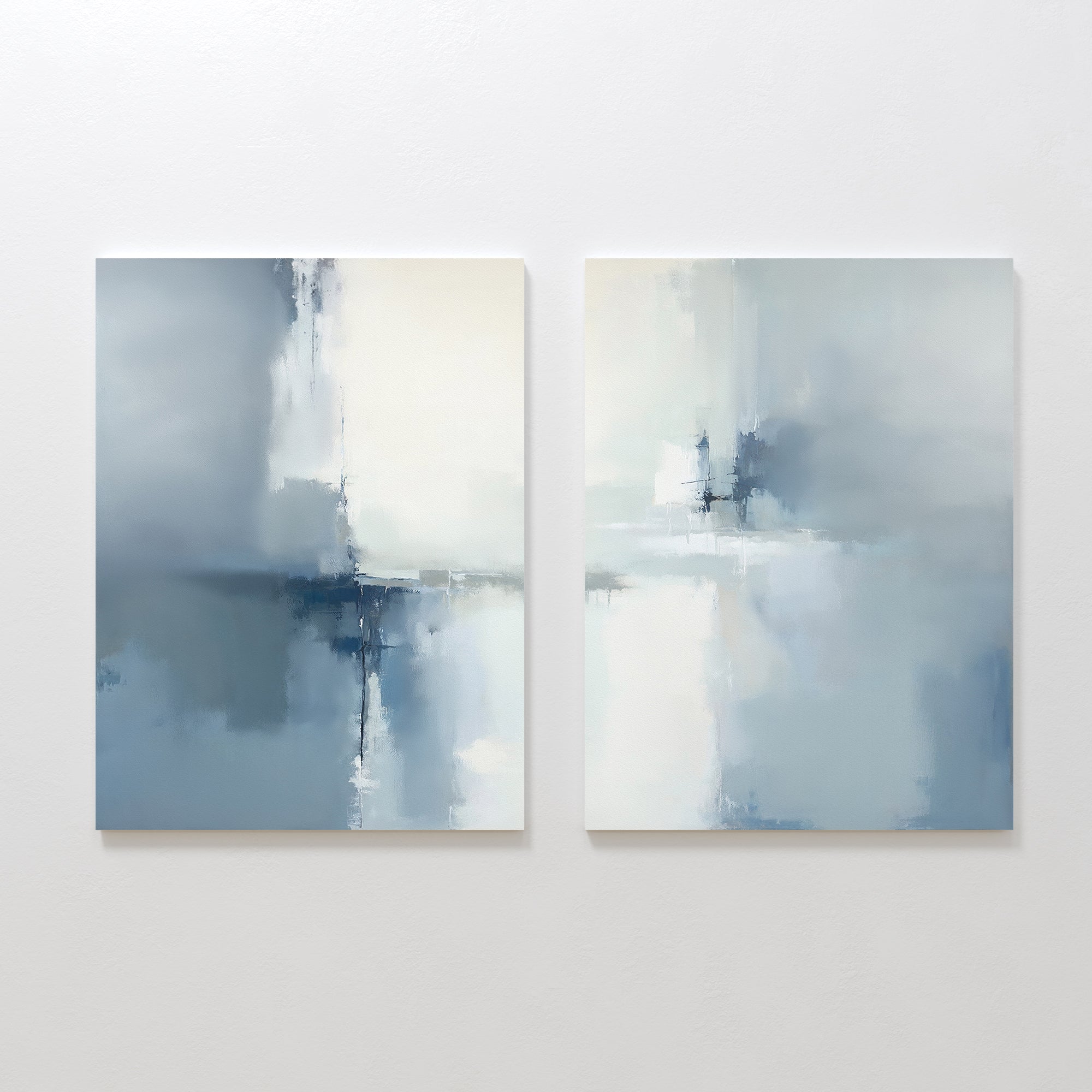 The Silver Cross Formation - Set Of 2 features abstract prints in soft blue, white, and gray tones with subtle lines. Displayed together on a white wall, these artworks create a serene, modern vibe ideal for contemporary living rooms.