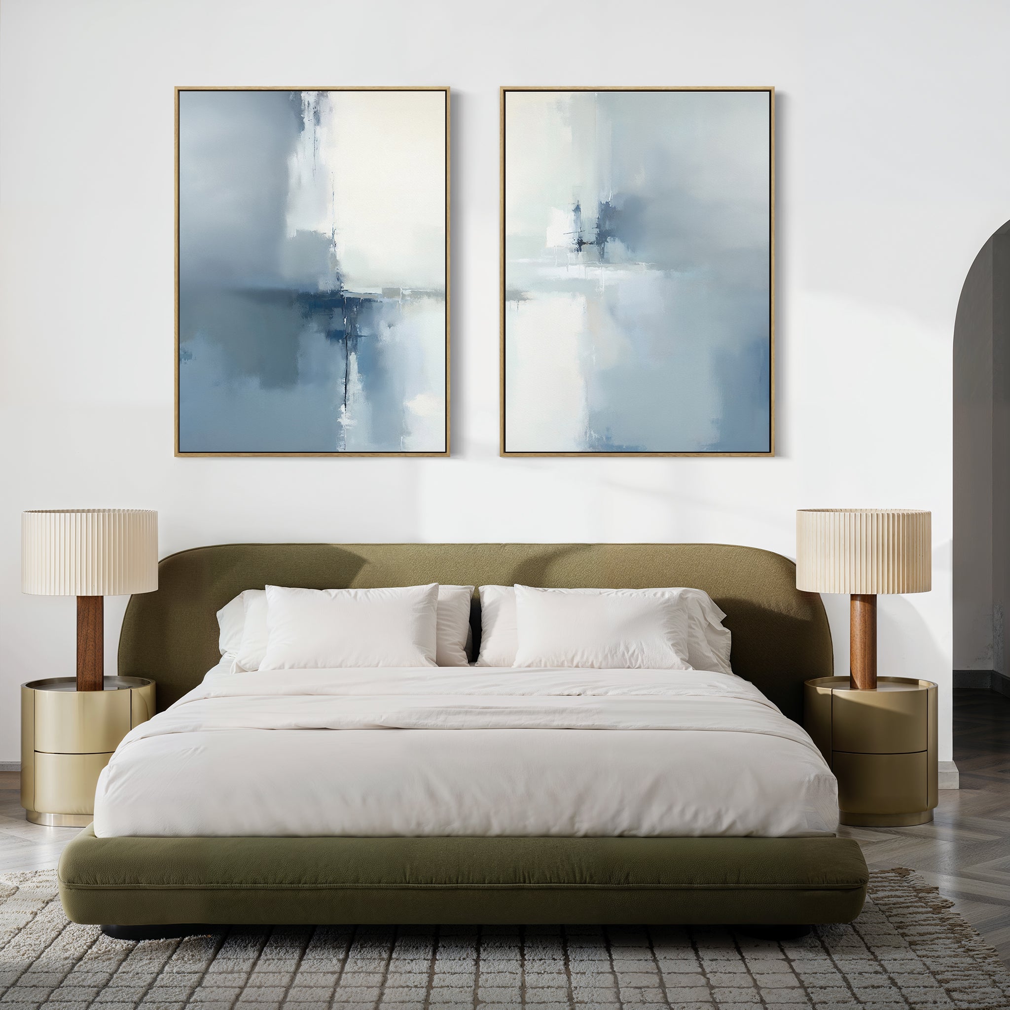 A modern bedroom featuring an olive green bed, white bedding, two beige nightstands with matching lamps, and the Silver Cross Formation - Set Of 2 atmospheric abstract prints above the bed.