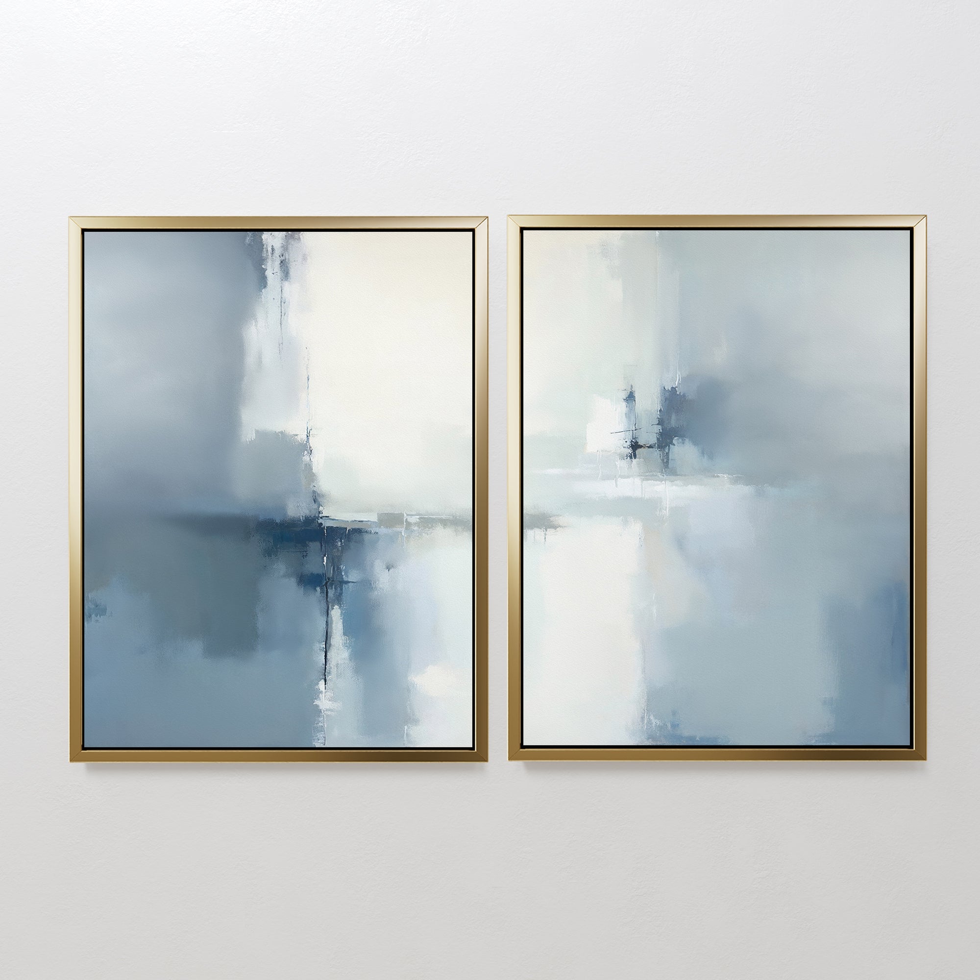 The Silver Cross Formation - Set Of 2 features two atmospheric abstract prints in silver frames, each blending blue, gray, and white tones for a calming effect—perfect for enhancing modern living room decor.