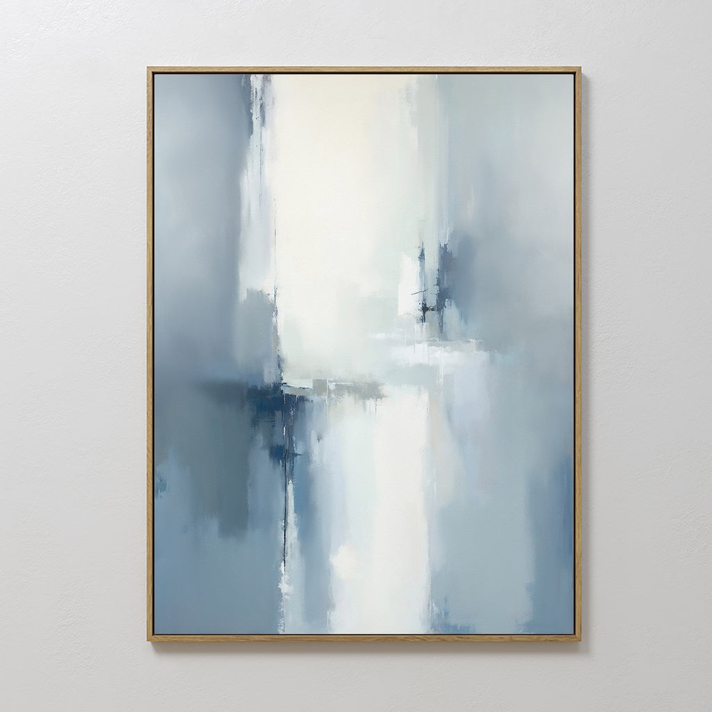 The Silver Cross Formation Canvas Art - Vertical features soft, blurred strokes in white, blue, and gray tones for a serene look. Framed in a thin gold frame and displayed on a plain white wall, it’s perfect for modern living rooms.