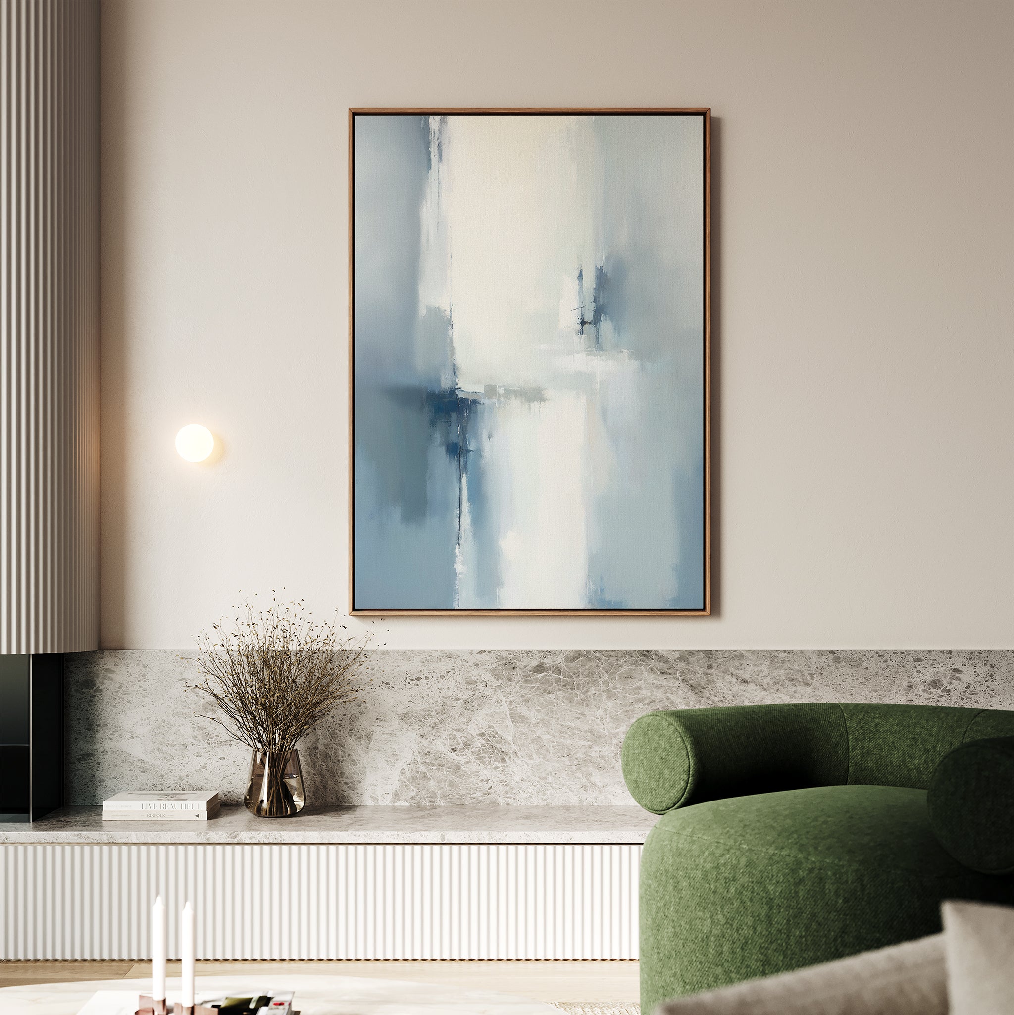A modern living room with a green curved sofa, marble bench, and vase with dried branches is complete with the Silver Cross Formation Canvas Art - Vertical hanging above the bench.