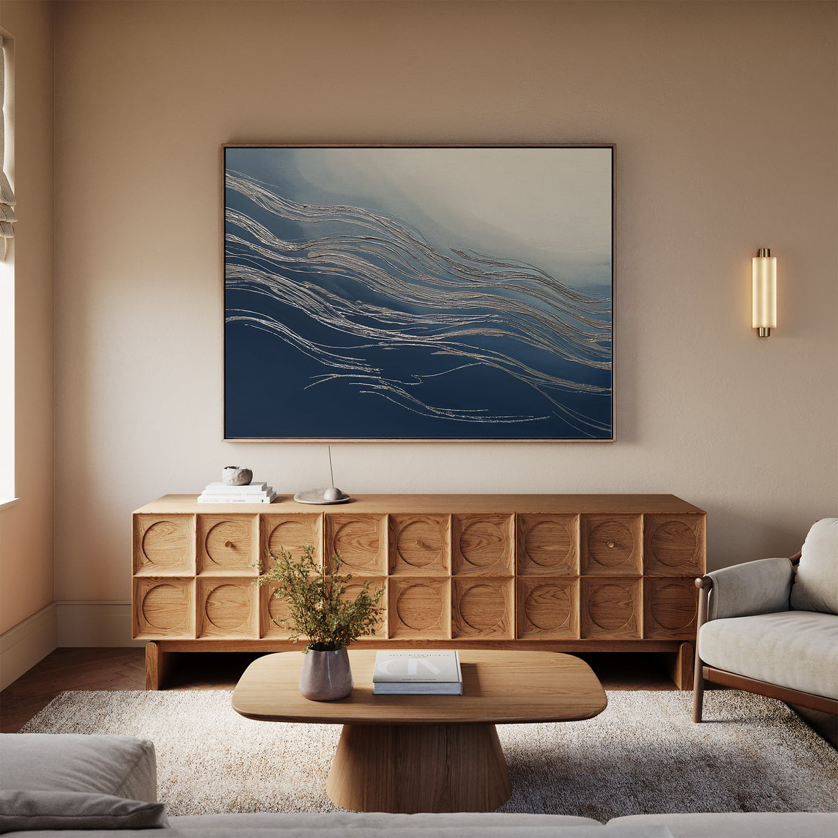 A modern living room with a wooden sideboard, low coffee table, beige sofa, rug, and the Silver Current Canvas Art - Horizontal above the sideboard. A wall sconce and vase with flowers add contemporary sophistication to the space.