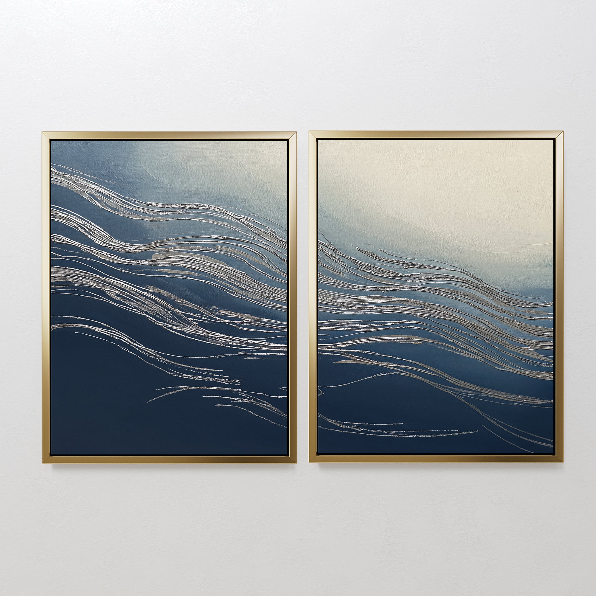 Silver Current - Set Of 2 features framed abstract prints with silver lines on dark blue and cream backgrounds, displayed side by side. This wall art evokes a contemporary sense of movement, reminiscent of waves or wind.