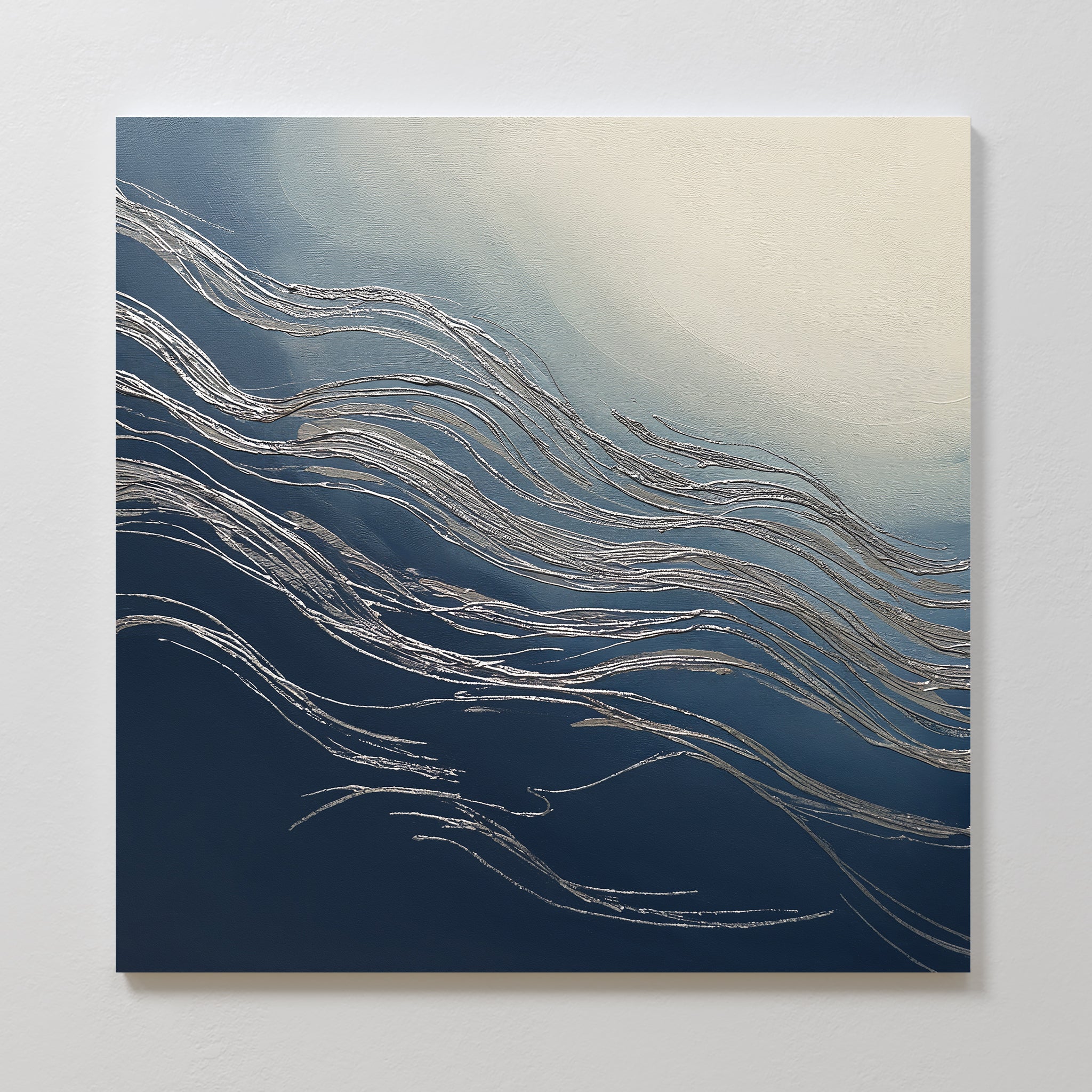 The Silver Current Canvas Art - Square features flowing silver lines on a gradient background from deep navy blue to soft cream, bringing contemporary sophistication and a sense of movement to any wall.
