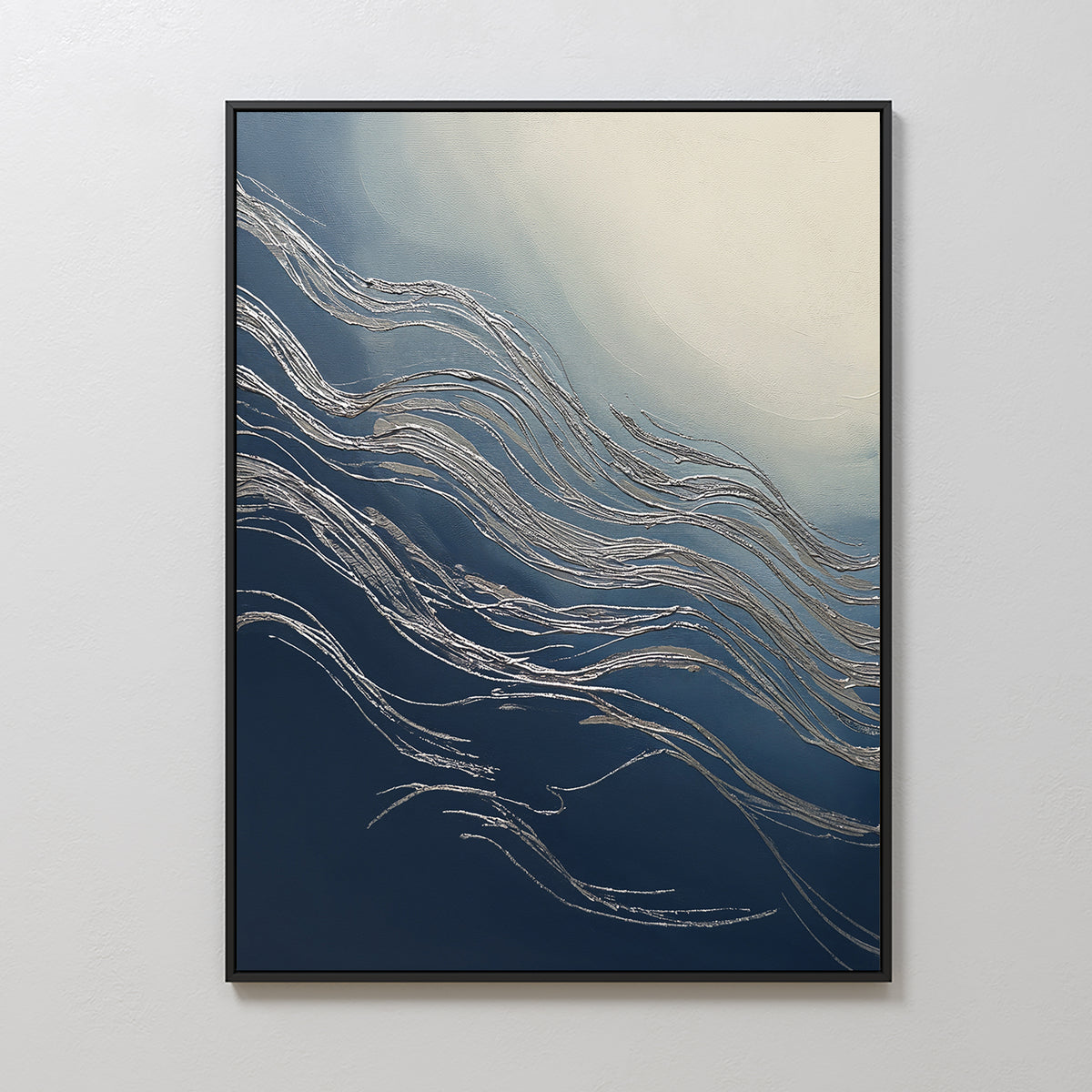 The Silver Current Canvas Art - Vertical features flowing silver lines set on a gradient from deep blue to cream, adding contemporary sophistication. Framed in black, this modern wall art is displayed on a white wall.
