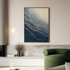 A modern living room with a green sofa, marble bench, vase of dried flowers, and Silver Current Canvas Art - Vertical brings contemporary sophistication to the light-colored space.