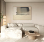 A modern living room features a beige sectional sofa, a low wooden coffee table with a dark bowl, and the Smoke Boundary Canvas Art - Horizontal above. A tall plant and natural light boost the calm atmosphere with soothing neutral tones.