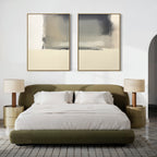A modern bedroom with a curved olive-green bed, white bedding, two round gold nightstands topped with Smoke Boundary - Set Of 2 pleated lamps, and large abstract wall art above the headboard. A textured rug covers the floor.