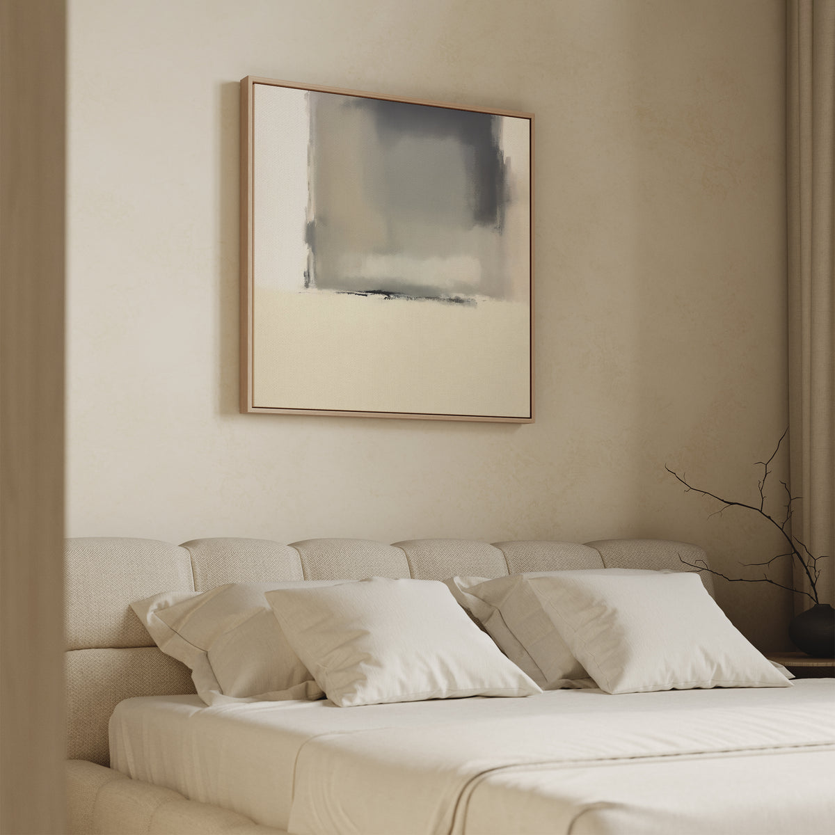 A minimalist bedroom features a beige upholstered bed with white bedding and three pillows. Above the bed, the Smoke Boundary Canvas Art - Square adds abstract, neutral style. A bare branch in a vase sits on a nightstand next to beige curtains.