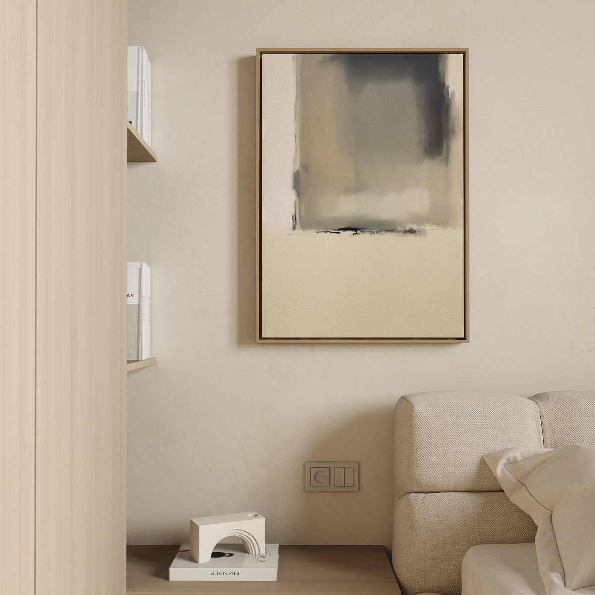 Minimalist living space with a beige couch, neutral elegance enhanced by the Smoke Boundary Canvas Art - Vertical in soft tones on the wall, light wood shelving with books, and a small geometric decor piece on a wooden floor next to the sofa.