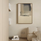 Minimalist living space with a beige couch, neutral elegance enhanced by the Smoke Boundary Canvas Art - Vertical in soft tones on the wall, light wood shelving with books, and a small geometric decor piece on a wooden floor next to the sofa.